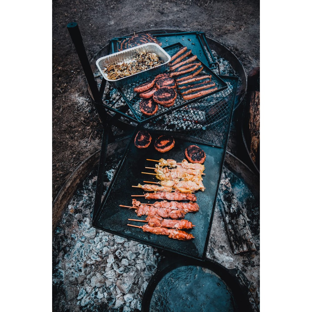 Campfire cooking grill combo with mesh grill racks and solid hotplate surface designed for campfire cooking, outdoor grilling and campsite meal preparation