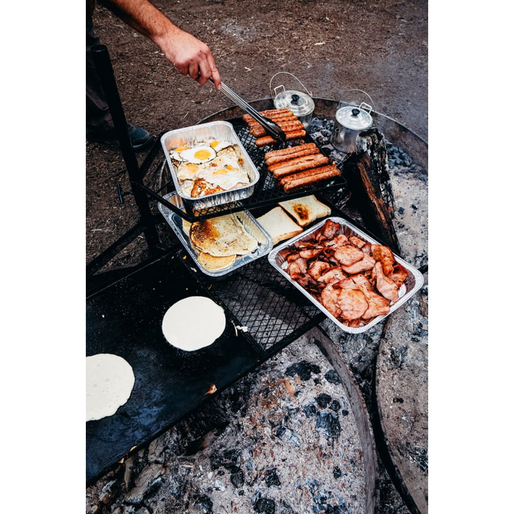 Campfire cooking grill combo with mesh grill racks and solid hotplate surface designed for campfire cooking, outdoor grilling and campsite meal preparation