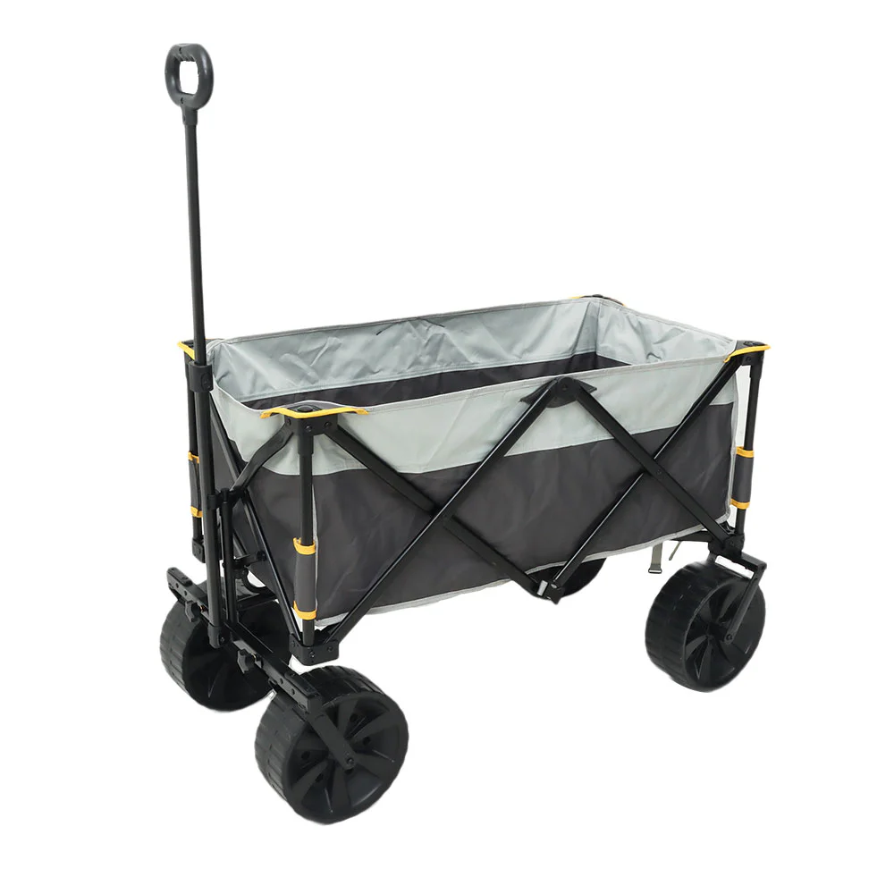 Campmaster folding all-terrain beach cart trolley with large wheels, fabric cargo compartment and extended pull handle.