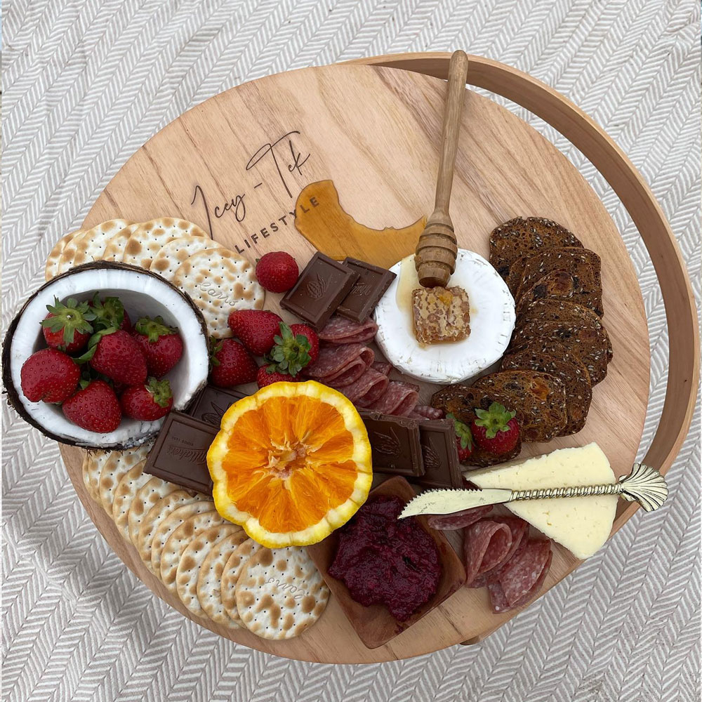 Icey-Tek insulated wicker picnic basket with a round wooden cheese board lid and curved carry handle, shown on a white background.