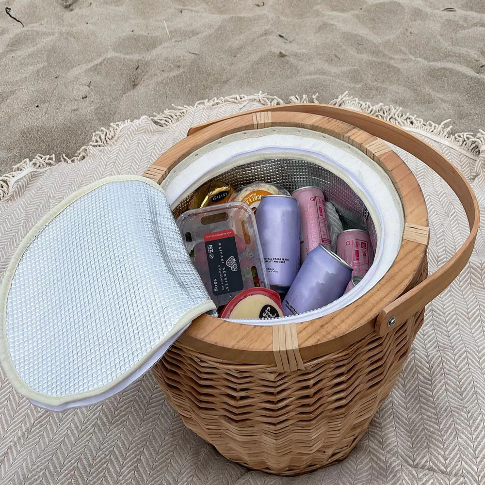 Icey-Tek insulated wicker picnic basket with a round wooden cheese board lid and curved carry handle, shown on a white background.