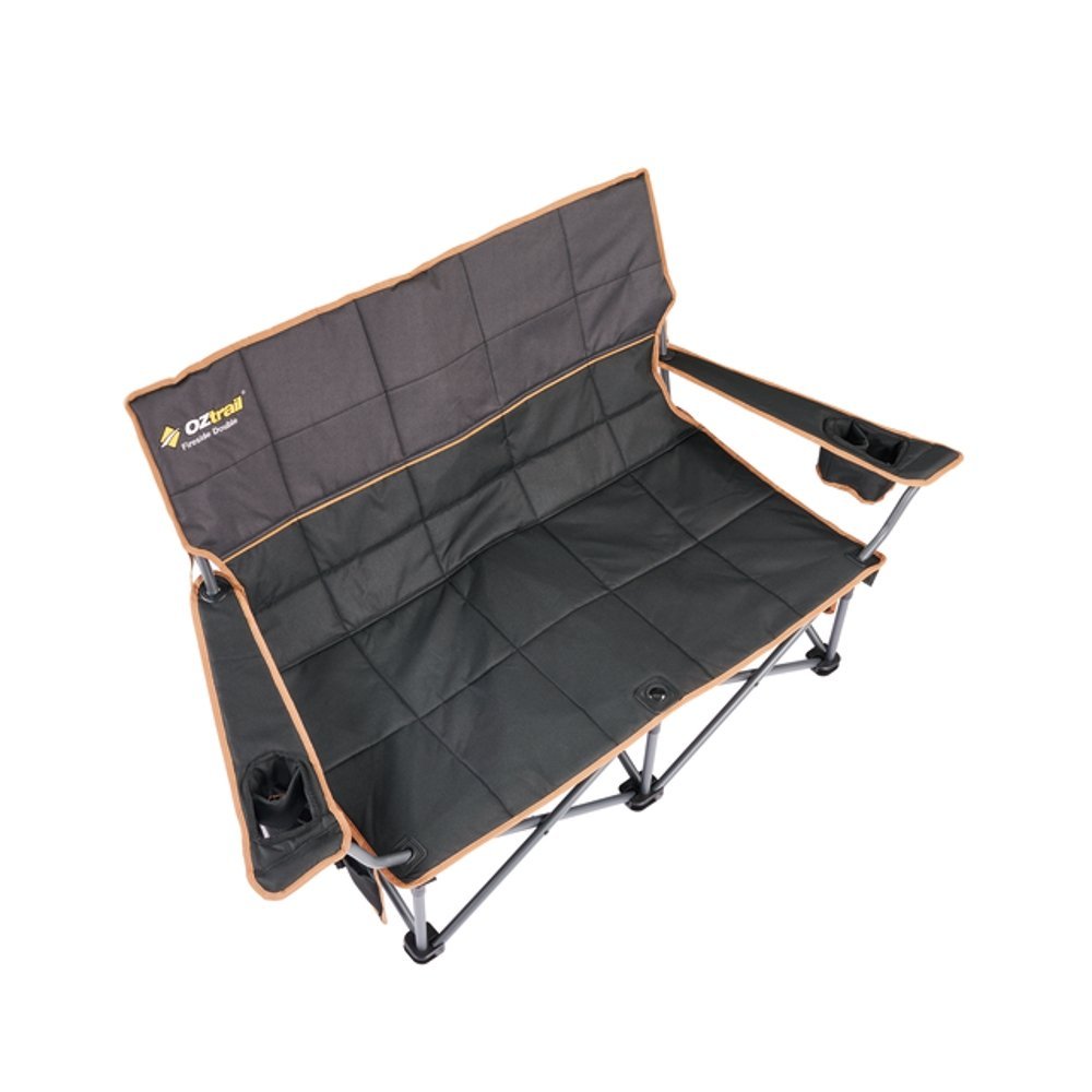 OZtrail Fireside Double Folding Camping Chair Black OZtrail Fireside double folding camping chair in black with padded dual seating, cup holders and sturdy foldable frame designed for camping, outdoor events and relaxing by the fire pit