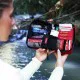 Compact personal first aid kit in a red zippered pouch with organized emergency medical supplies for hiking, camping, travel, outdoor adventures, and everyday preparedness.