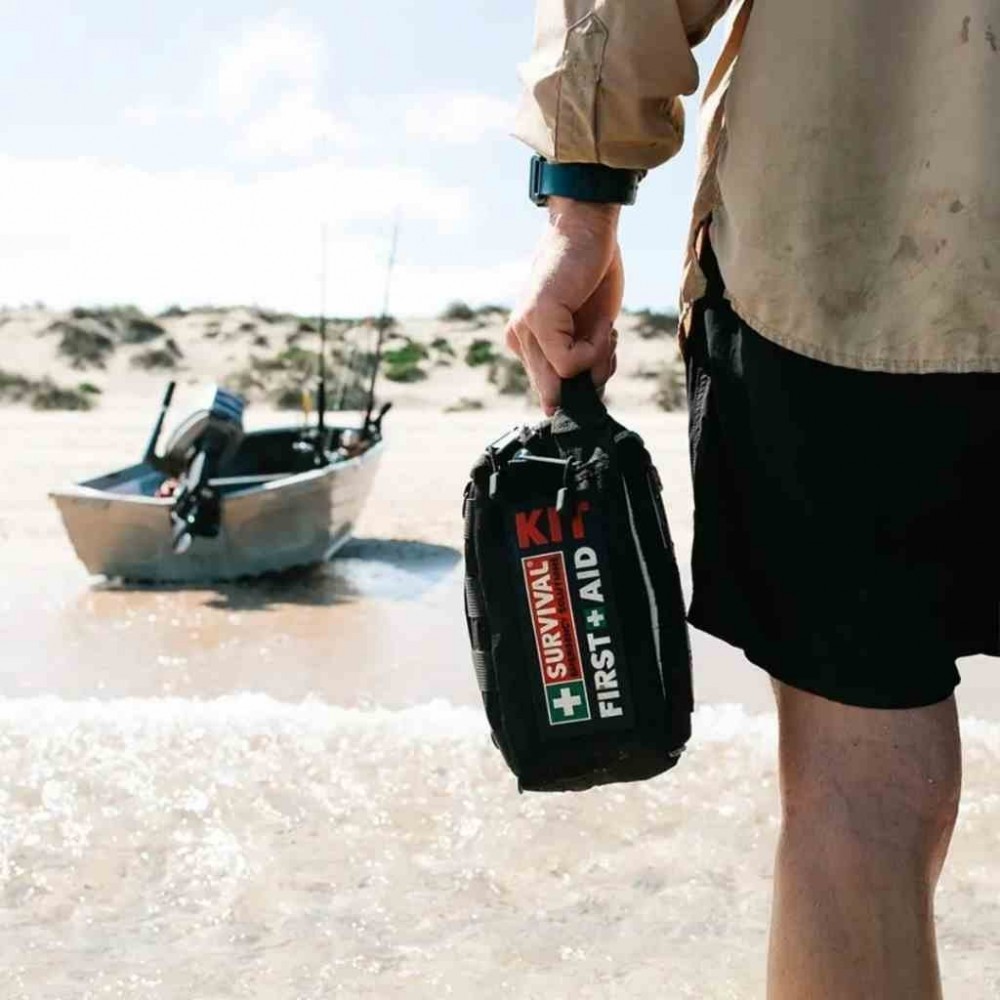 100+ piece vehicle emergency first aid kit in a compact zippered case with organized medical supplies for roadside emergencies, travel, camping, and outdoor safety.