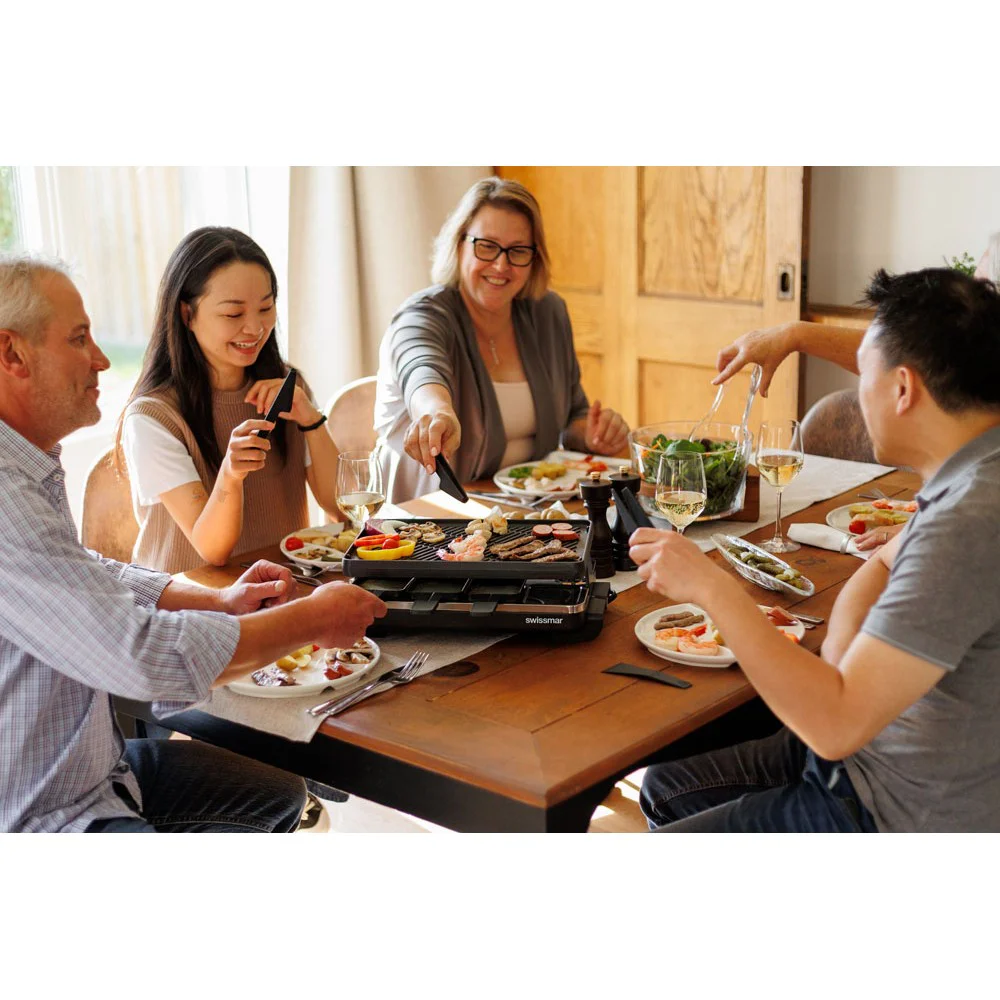 Swissmar Verso 8 person raclette grill with reversible cast iron grill and griddle top, individual raclette pans and adjustable heat control for indoor or outdoor dining.