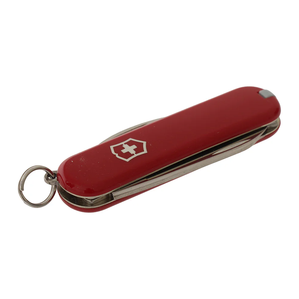 Victorinox Rally multi-tool pocket knife featuring a compact 58mm red handle and classic Swiss Army Knife design. This lightweight keychain-sized tool includes a small stainless steel blade, nail file with screwdriver tip, magnetic Phillips screwdriver, b