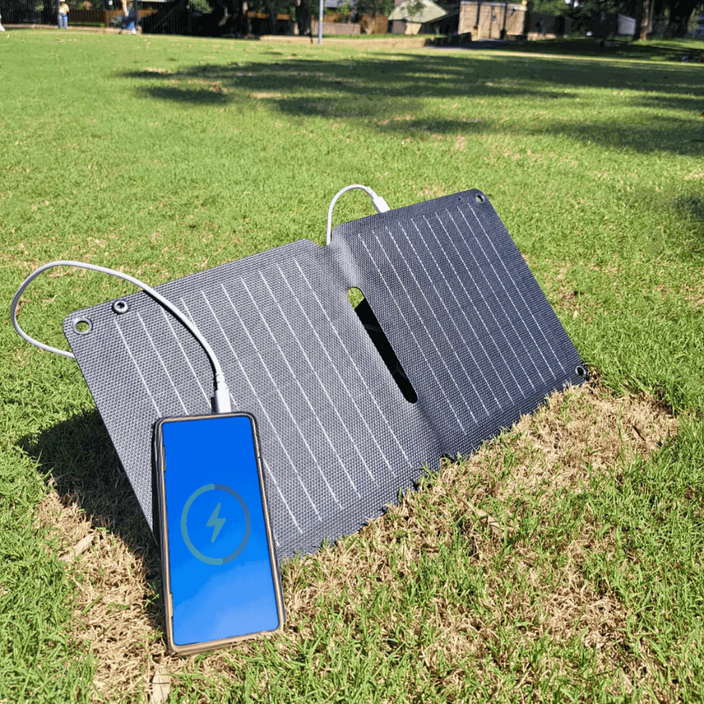 Xtorm SolarBooster 14W portable solar charger with foldable dual-panel design and lightweight construction for charging smartphones, power banks and USB devices during camping, hiking, travel and outdoor adventures.