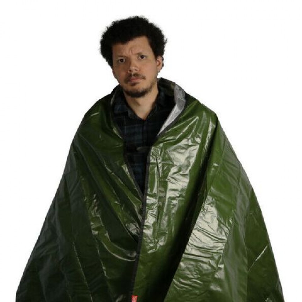 sol-sport-utility-blanket-worn.jpg Person wearing SOL green survival blanket with reflective lining for emergency warmth