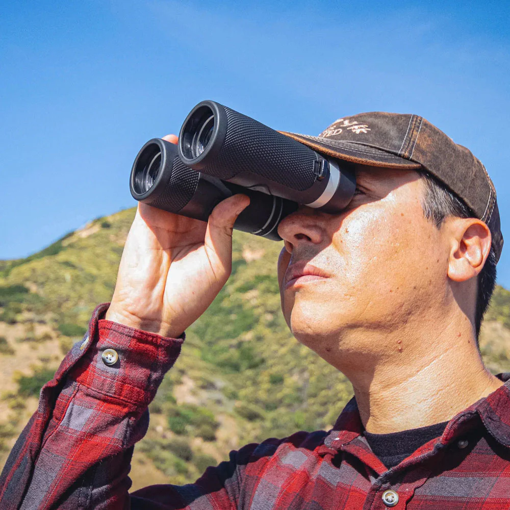 10x42 compact binoculars with textured black body and multi-coated lenses, delivering clear long-range viewing for birdwatching, wildlife observation, hiking, and outdoor adventures.