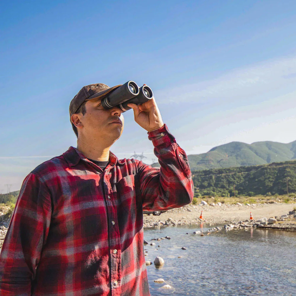 10x42 compact binoculars with textured black body and multi-coated lenses, delivering clear long-range viewing for birdwatching, wildlife observation, hiking, and outdoor adventures.