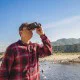 10x42 compact binoculars with textured black body and multi-coated lenses, delivering clear long-range viewing for birdwatching, wildlife observation, hiking, and outdoor adventures.