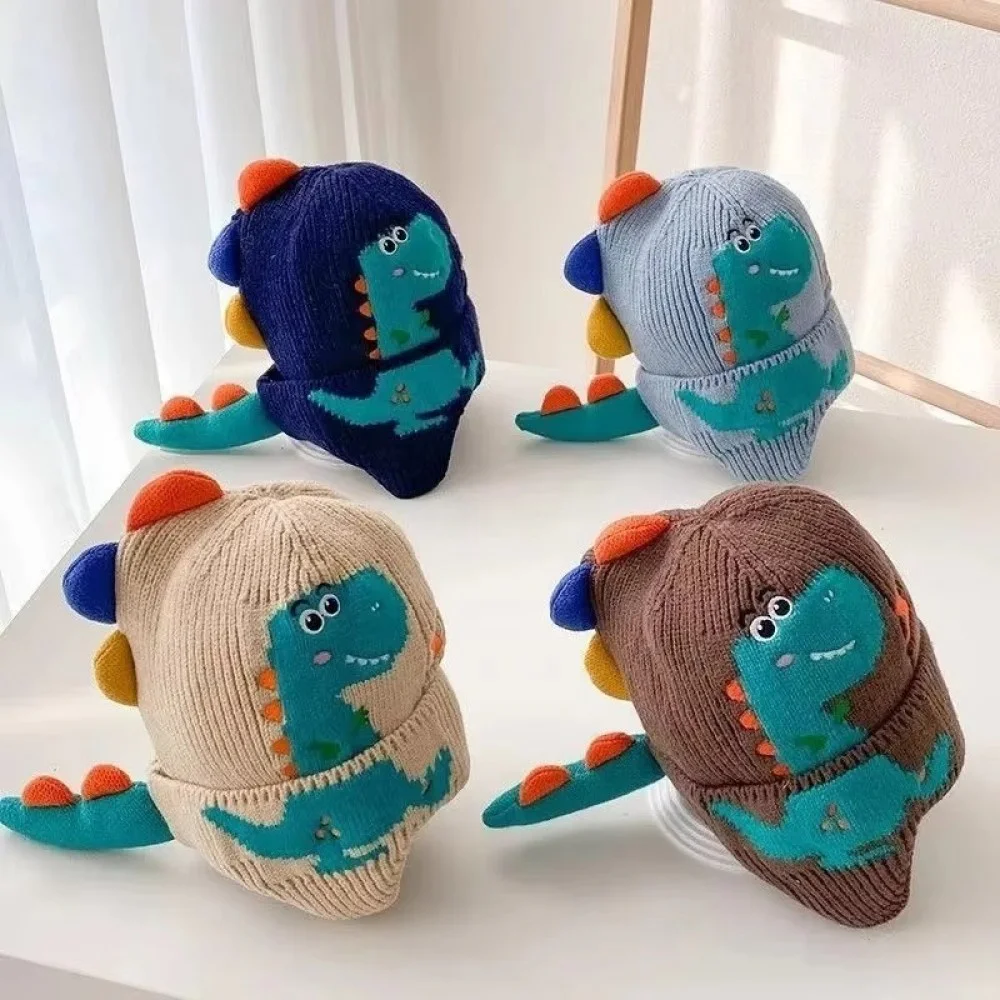 3D Dinosaur Kids Winter Beanie with Ear Protection Adorable knitted kids winter beanie featuring a playful 3D dinosaur design with colorful spikes, ear flaps, and a soft ribbed cuff. Made from warm, comfortable knit fabric, this toddler and children's hat provides excellent cold-weather protection for the