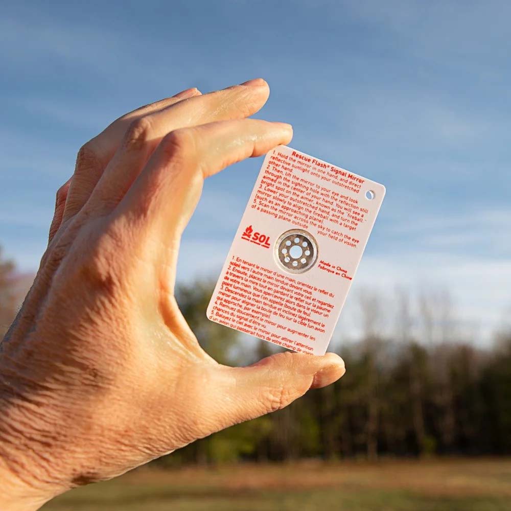 sol-rescue-flash-mirror-hand-use.jpg Person using SOL Rescue Flash Mirror to reflect light toward rescue aircraft