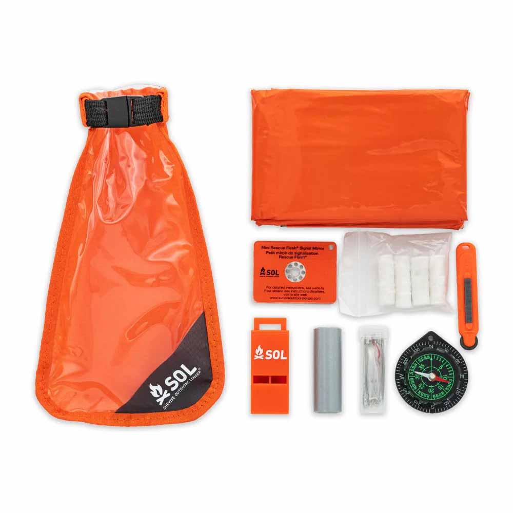 SOL Scout Survival Kit – Contents Displayed Full contents of the SOL Scout Survival Kit including survival blanket, whistle, mirror, compass, fire starters, and dry bag