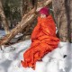 Hiker Using SOL Emergency Bivvy in Backcountry Conditions Tramper Using Emergency Bivvy Bag – Survival Shelter for Cold Weather NZ