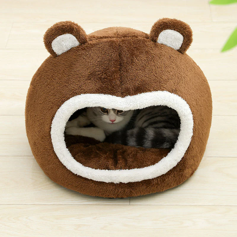 Brown bear ear plush pet house with soft white trim and a cat resting inside