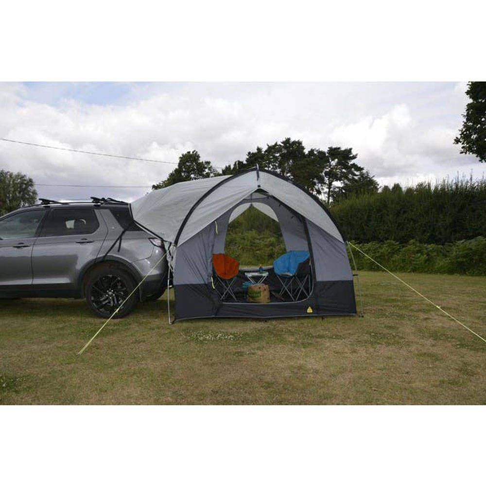Dometic Tailgater Travel Pod SUV Awning Tent Dometic Tailgater Travel Pod attached to SUV creating sheltered camping space with enclosed awning tent