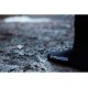 Black waterproof thermal socks worn outdoors on wet muddy trail for winter hiking trekking and walking comfort