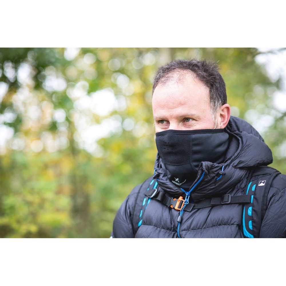 Man wearing black windproof thermal face mask outdoors during hiking and cold weather trekking adventure