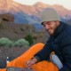 Lixada Sleeping Bag for Outdoor Camping Adventures Camper using orange Lixada ultralight sleeping bag outdoors in mountain campsite environment during cold weather camping