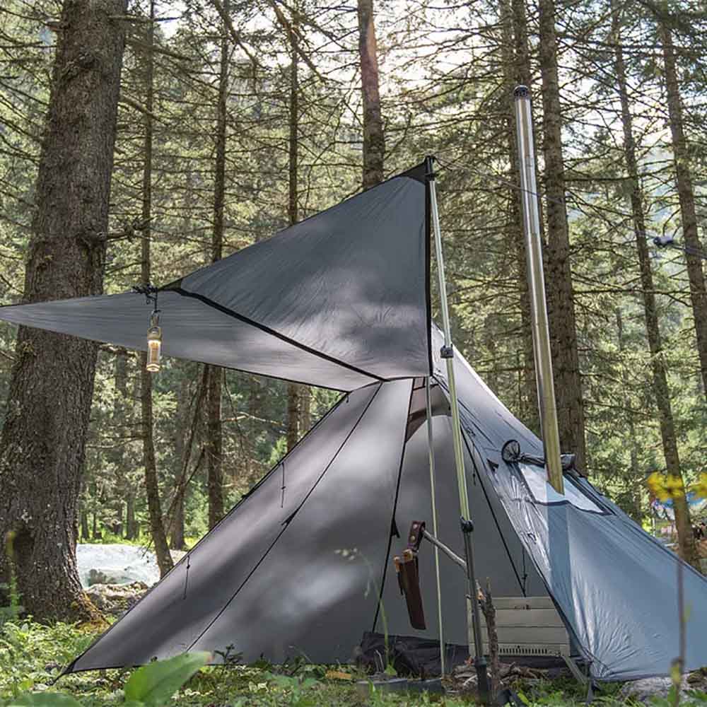 Pomoly HUSSAR 20 Tent with Awning and Stove Setup Pomoly HUSSAR 20 hot tent featuring a canopy setup with lantern hanging and stove pipe fitted through the jack.