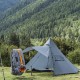 Pomoly HUSSAR 20 Tent in Open Field Pomoly HUSSAR 20 hot tent pitched in an open grassy area with sleeping bag hung on a line nearby.
