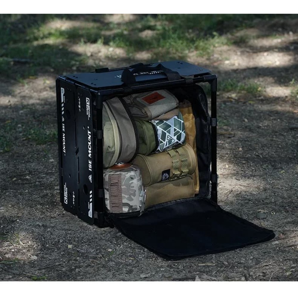 Black storage unit beneath the table filled with camping bags and equipment.