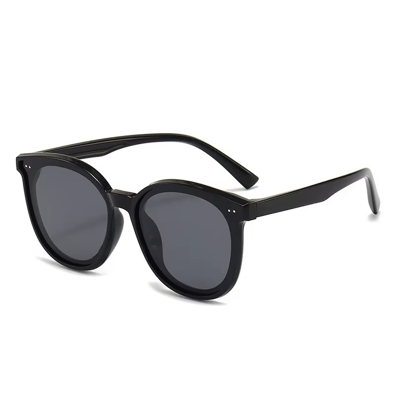 Kids polarized sunglasses with a classic round black frame and dark UV400 lenses, offering comfortable eye protection for outdoor activities.