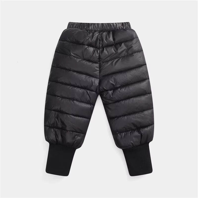 Lightweight insulated kids winter down pants designed with a quilted puffer construction, elastic waistband, and ribbed ankle cuffs for enhanced warmth and comfort. These windproof snow trousers help retain body heat while protecting children from cold we