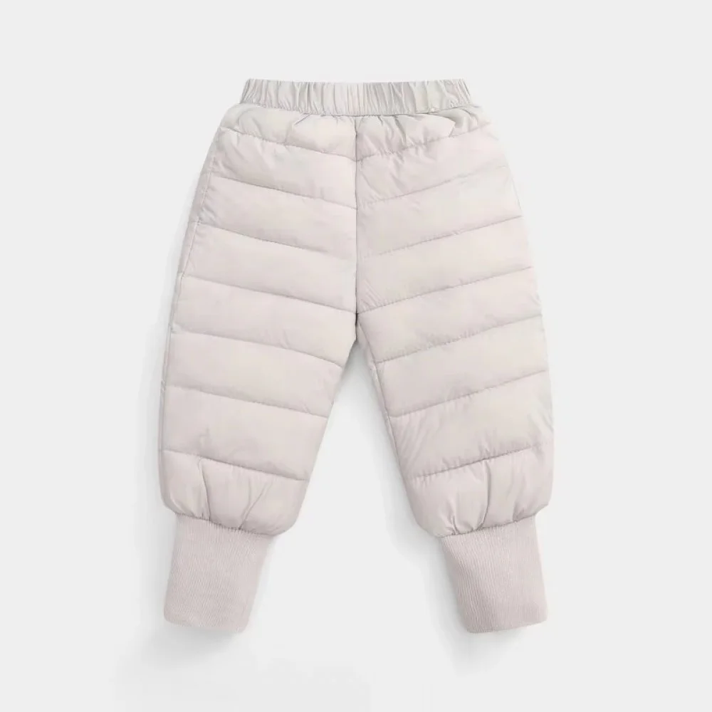 Lightweight insulated kids winter down pants designed with a quilted puffer construction, elastic waistband, and ribbed ankle cuffs for enhanced warmth and comfort. These windproof snow trousers help retain body heat while protecting children from cold we
