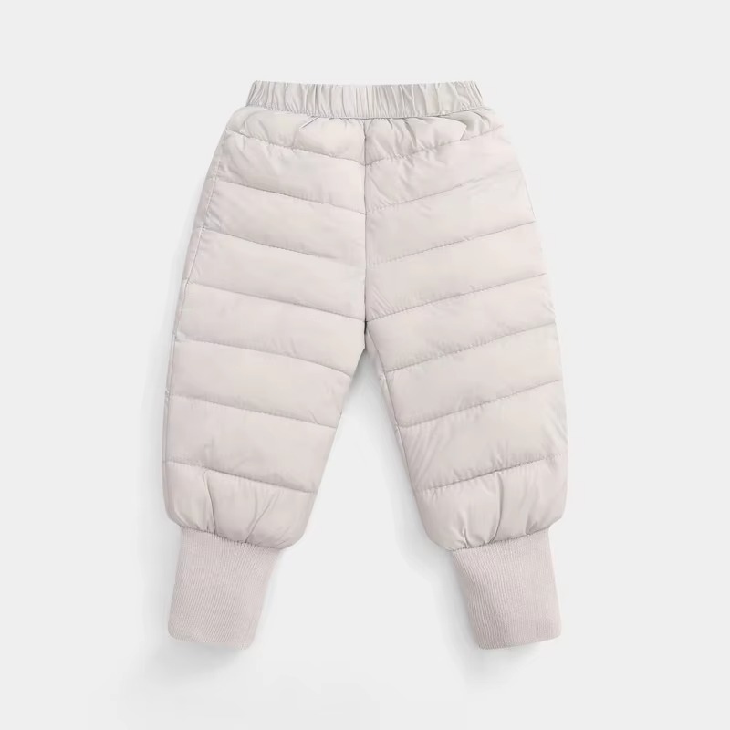 Lightweight insulated kids winter down pants designed with a quilted puffer construction, elastic waistband, and ribbed ankle cuffs for enhanced warmth and comfort. These windproof snow trousers help retain body heat while protecting children from cold we