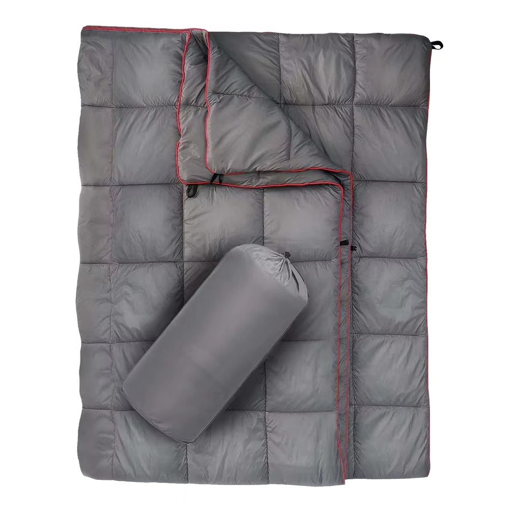 Lightweight down camping blanket featuring insulated quilted construction, water-resistant outer fabric, and compact packable design with included storage sack. This versatile outdoor blanket provides exceptional warmth for camping, backpacking, hiking, v