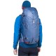 Rear view of a hiker wearing the blue Fang 35 Backpack with top lid and gear loops visible