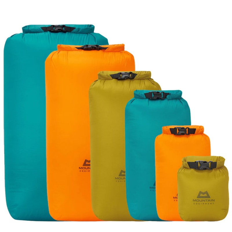 Set of colorful Mountain Equipment lightweight dry bags in various sizes and colors including blue, orange, and green