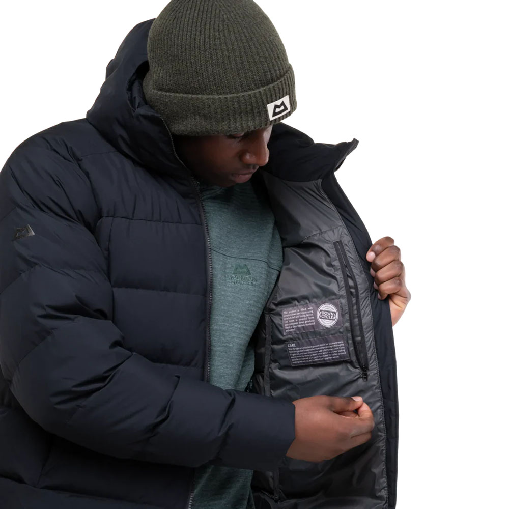 Black insulated hooded jacket with box wall construction and Mountain Equipment logo on chest