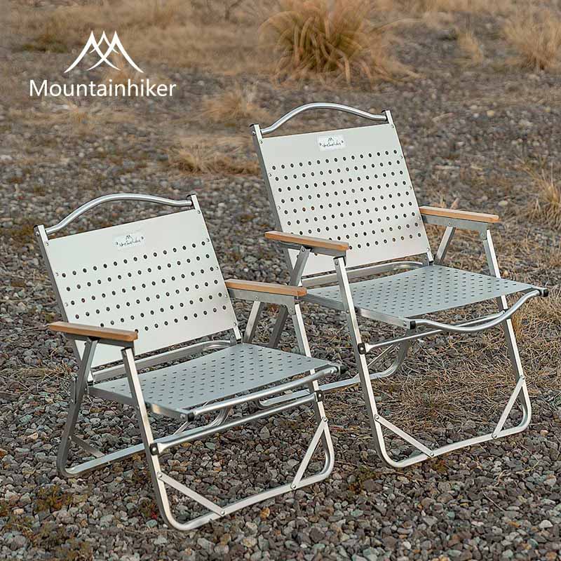Four Mountainhiker FoldPro aluminum folding camping chairs in black and white color variations displayed on a white background.