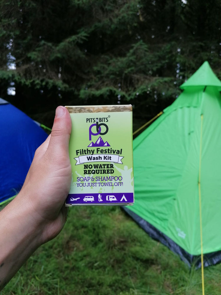Complete Pits & Bits festival wash kit including shampoo, body wash, and compostable wipes, displayed with outer packaging