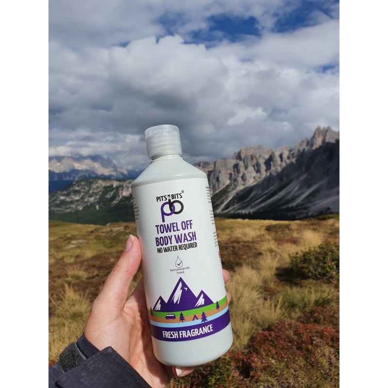 Front view of Pits & Bits Towel Off Body Wash bottle with purple mountain design and “Fresh Fragrance” label on white background.