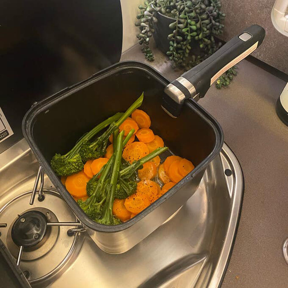 Smartspace stackable camping pot cooking vegetables on a caravan stove with detachable handle attached