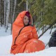 Woman Using Orange SOL Escape Bivvy in Winter Emergency-ready high-visibility SOL Escape Bivvy used outdoors in snow