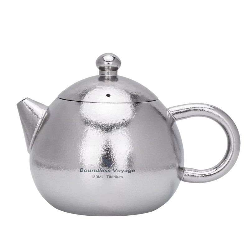 Boundless Voyage 180ml titanium teapot featuring a lightweight hammered-finish titanium body, integrated handle, precision pouring spout, and fitted lid with steam vent. Designed for brewing loose-leaf tea with a built-in strainer at the spout, this compa