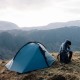 Wild Country Helm Elite 2 lightweight two-person tent pitched with trekking pole support and guy lines for stability