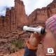 Using Brunton Echo Zoom Monocular Outdoors Woman using Brunton Echo Zoom Monocular to observe rock formations in a desert landscape.