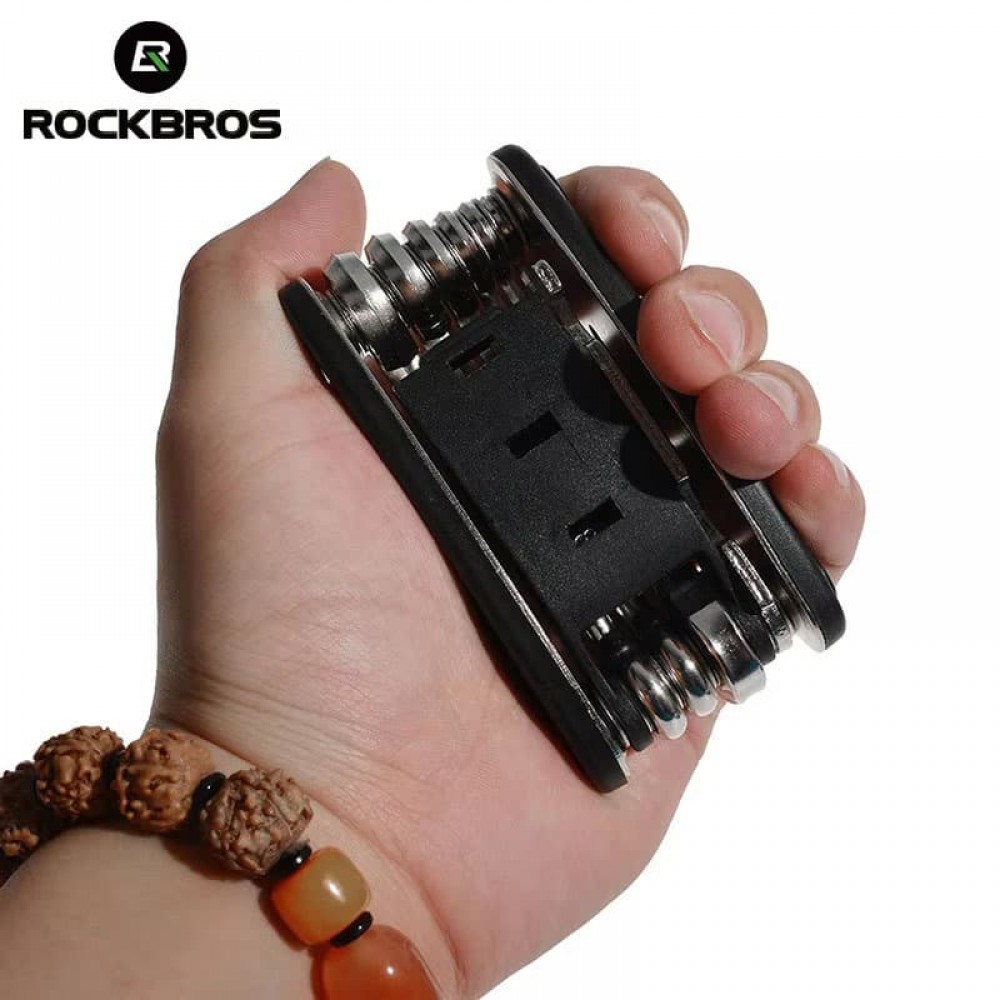 Compact and portable ROCKBROS 16 in 1 multi tool held in hand, ideal for road and mountain bike repairs.