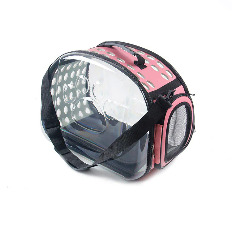 Pink transparent pet carrier bag with clear front panel, ventilation holes, mesh side window and shoulder strap for small dogs and cats.