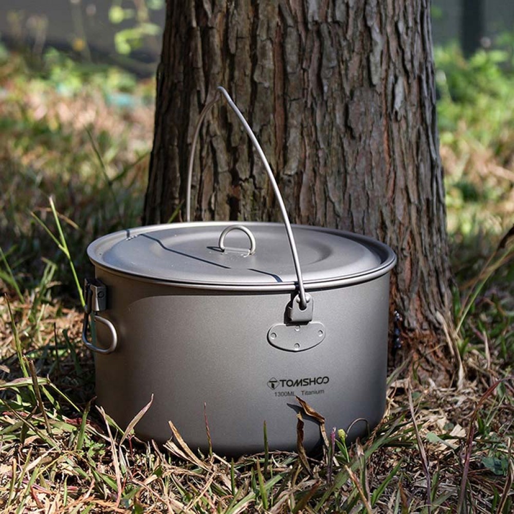 Image of a lightweight titanium pot with folding handle and measurement marks by Tomshoo.
