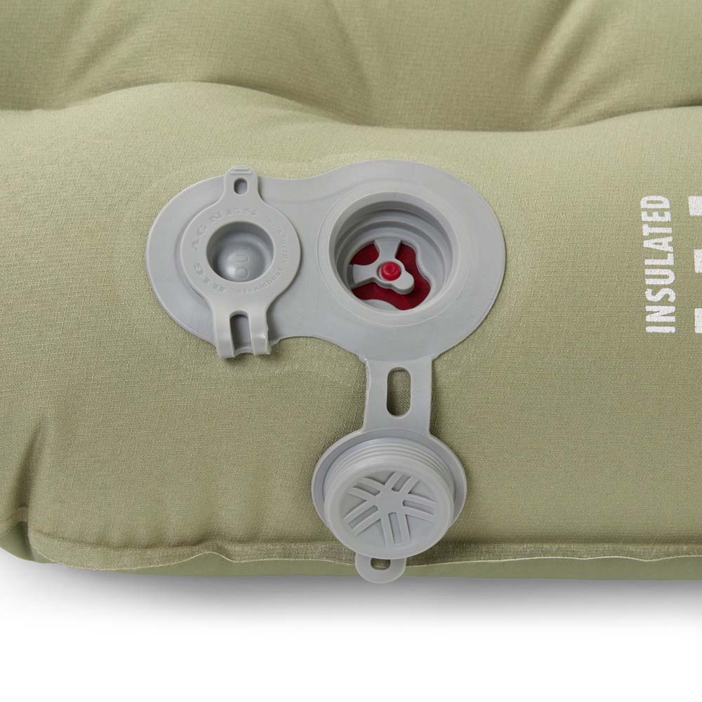 Close-up of Big Agnes Campmeister Deluxe Insulated Sleeping Mat valve with inflation and deflation openings exposed, showing red valve interior.