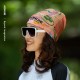Woman wearing an AONIJIE multifunctional headband with colorful abstract print styled as a beanie, perfect for outdoor sports and running.