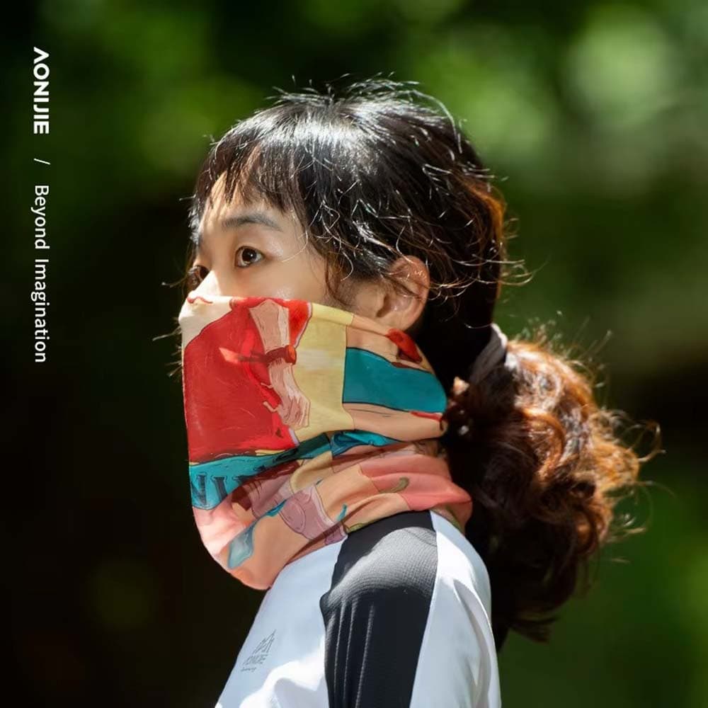 Woman wearing an AONIJIE multifunctional headband with colorful abstract print styled as a neck gaiter for sports and outdoor activities.