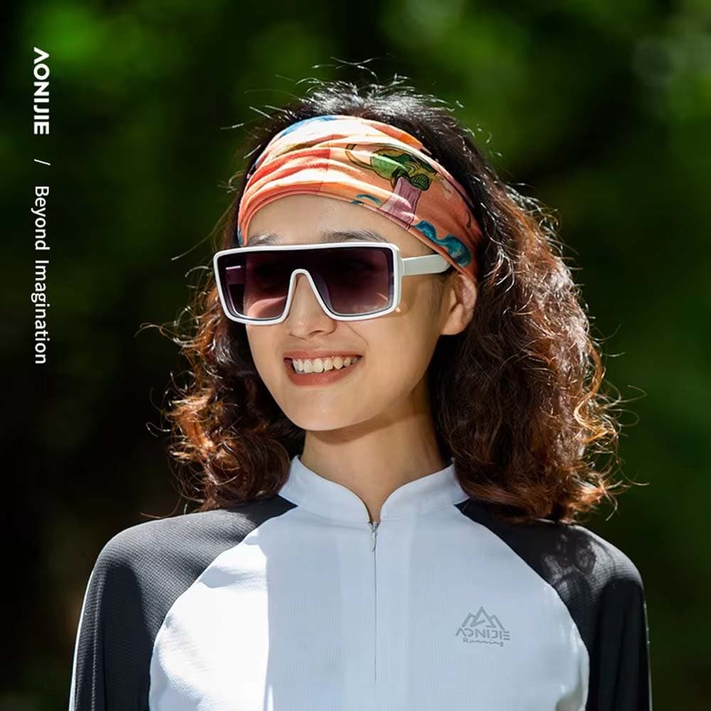 Woman wearing an AONIJIE multifunctional headband with colorful abstract print styled as a hairband, suitable for running, cycling, and casual wear.